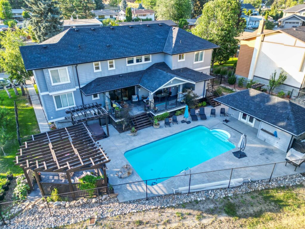 Aerial view of the house and its pool, showing the deck, pergola and the size of the lot relative to its neighbours.