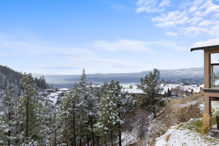 Snow-dusted Kelowna hillside neighbourhood looking west across Okanagan Lake